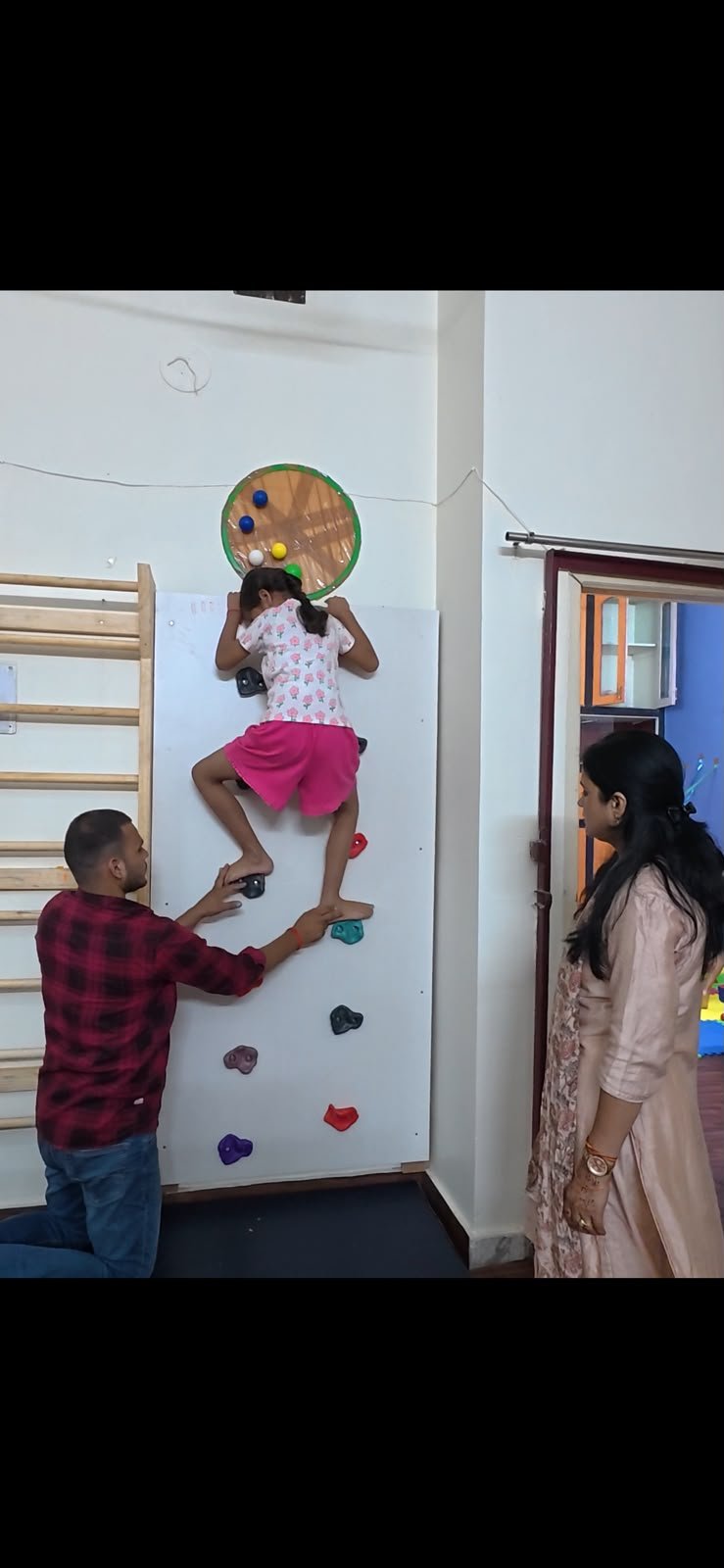 Child climbing wall therapy activity